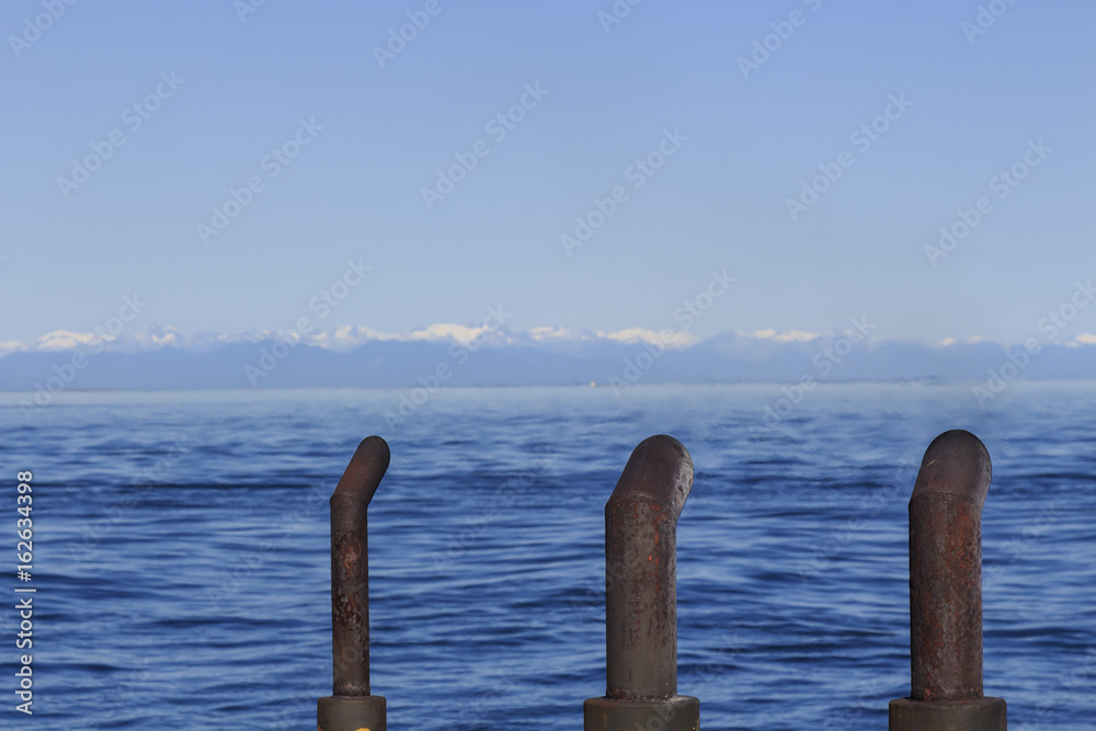 Three boat funnels with sea and mountains Three boat funnels with sea and mountains
