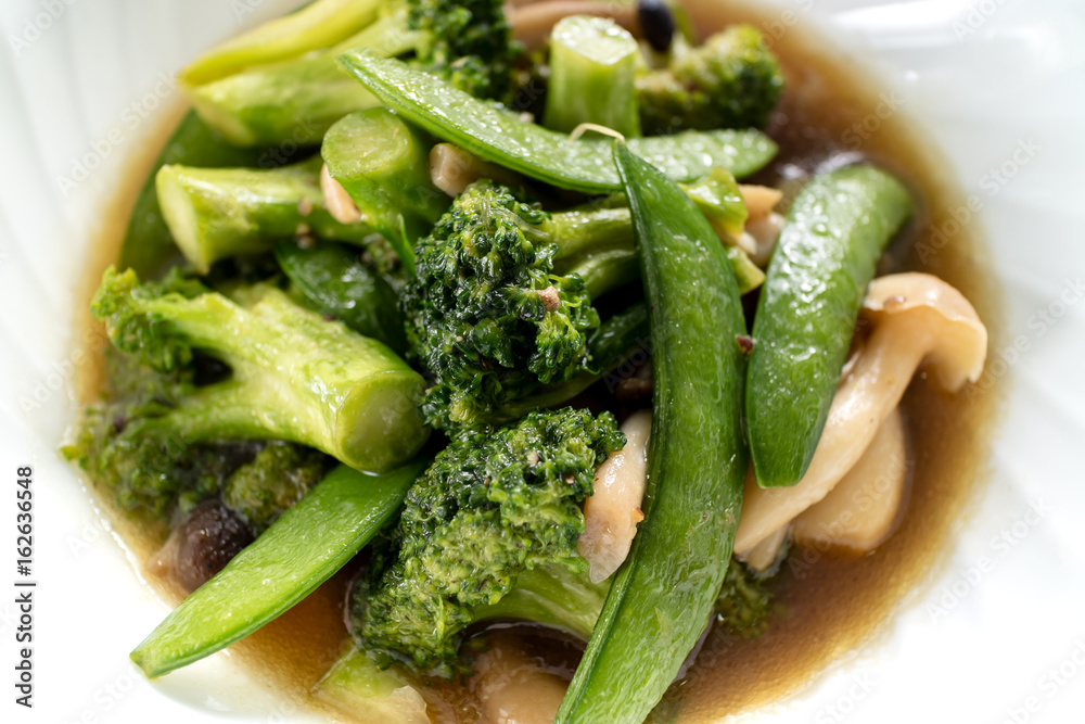 homemade stir-fried vegetable combination, broccoli and garden pea with mushroom homemade stir-fried vegetable combination, broccoli and garden pea with mushroom
