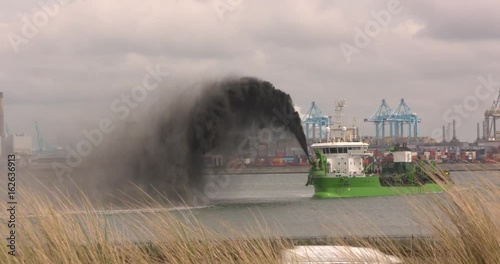 dredging operation of hopper dredger Reynaert, rainbowing black mud when the deepening of Alexia Haven, Maasvlakte II  ROTTERDAM SEAPORT - MAY 2017