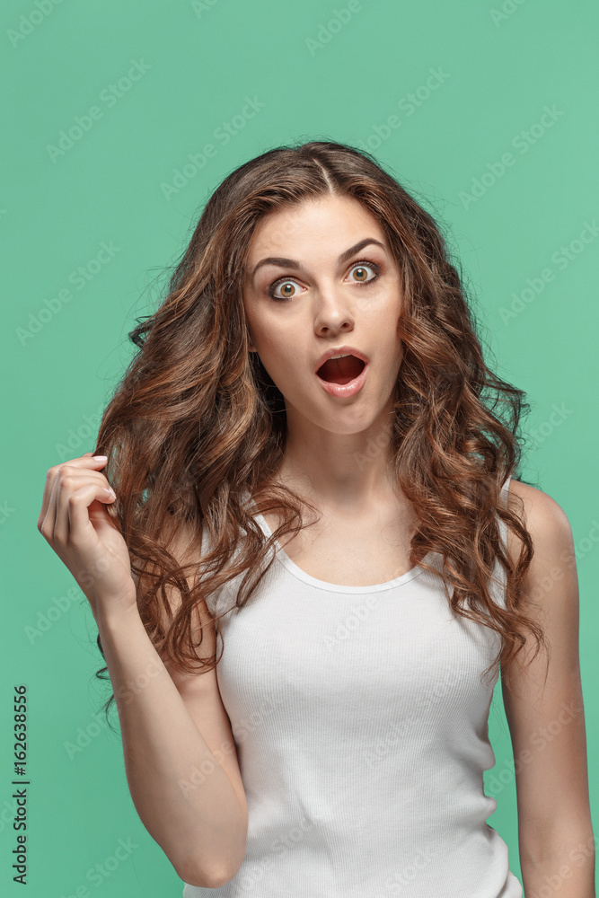 Portrait of young woman with shocked facial expression Portrait of young woman with shocked facial expression