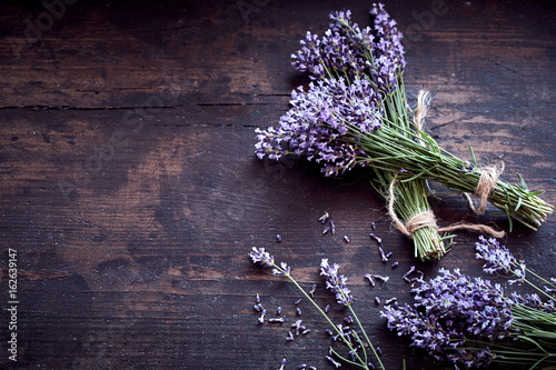 Fototapeta Naklejka Na Ścianę i Meble -  Bunches of fresh aromatic lavender on rustic wood