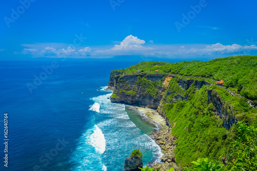 Amazing view of steep cliff and ocean at Uluwatu in Bali, Indonesia photo
