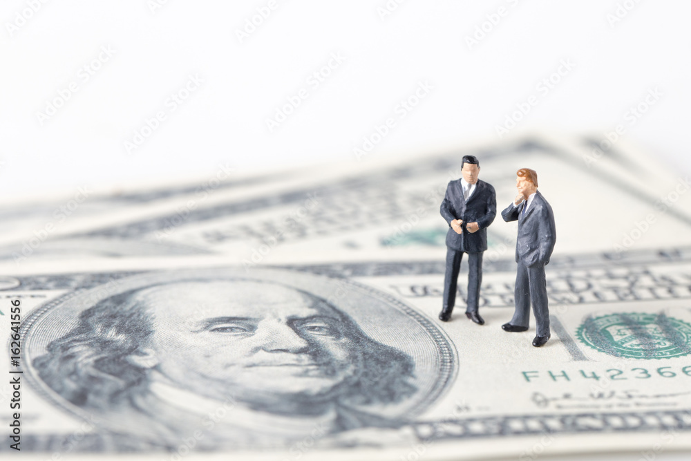 Miniature model group of businessman thinking with project for investment standing together on money. Miniature model group of businessman thinking with project for investment standing together on money.