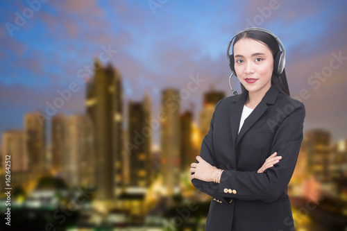 Support phone operator in headset at city background, woman with call center concept, 20-30 years old. photo