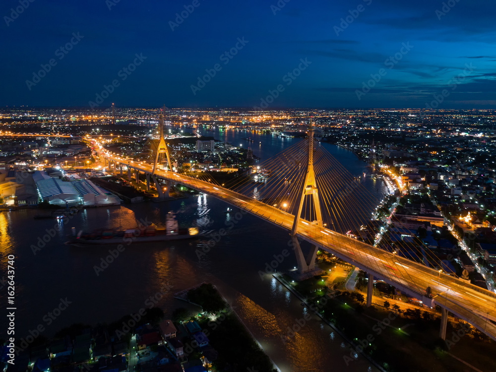 Top view over the highway,expressway and motorway at night, Aerial view interchange of a city, Shot from drone,Expressway is an important infrastructure in Thailand