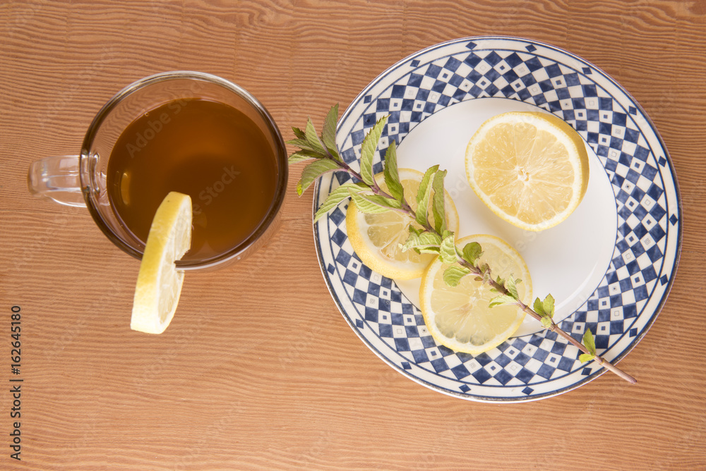 Chai tea with lemon slices and green foliage Chai tea with lemon slices and green foliage