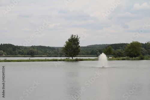 The fountain on the lake in the park. photo