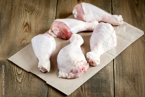 Raw uncooked chicken legs Raw chicken on kraft paper Chicken meat photo