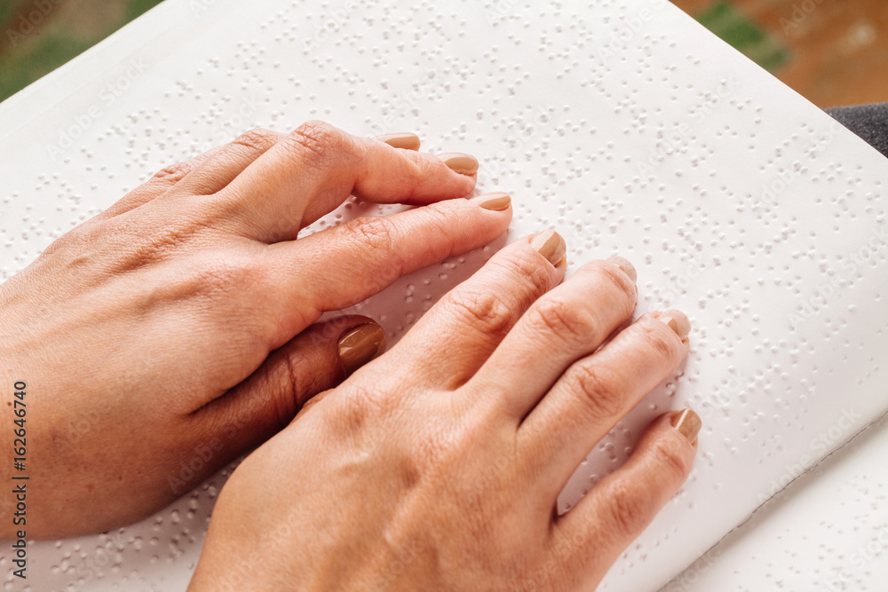 Finger read braille alphabet in white paper. Stock Photo | Adobe Stock