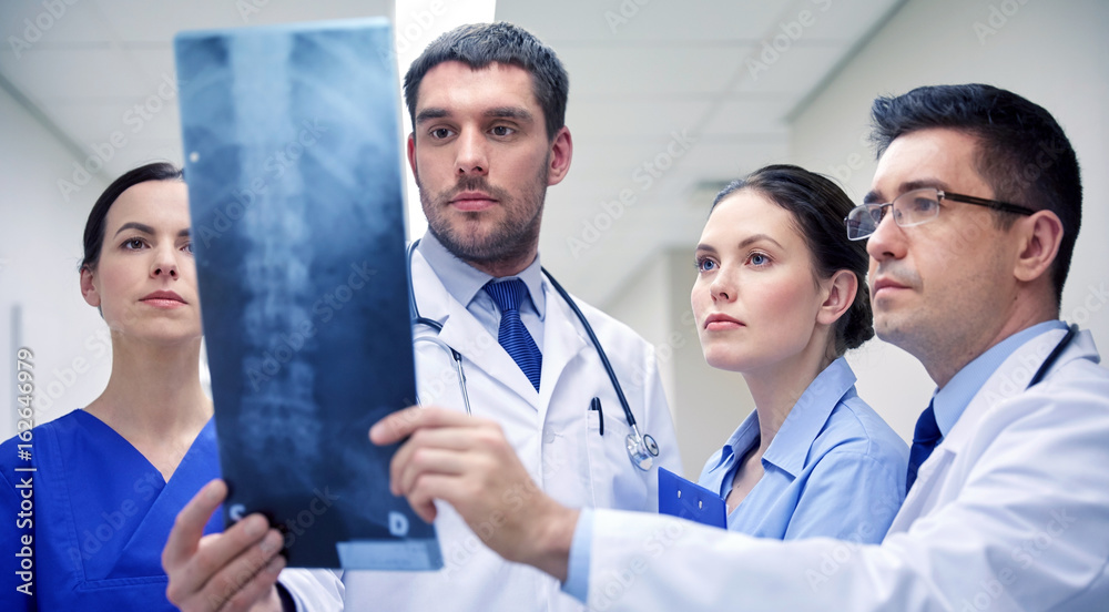 group of doctors looking at x-ray scan image group of doctors looking at x-ray scan image