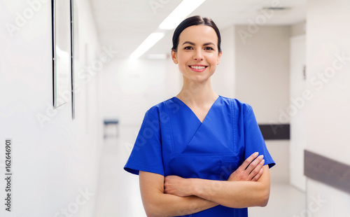 happy doctor or nurse at hospital corridor photo