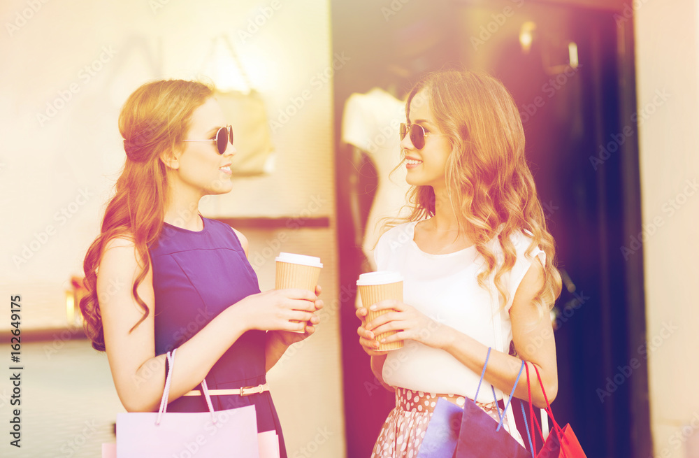 young women with shopping bags and coffee at shop young women with shopping bags and coffee at shop