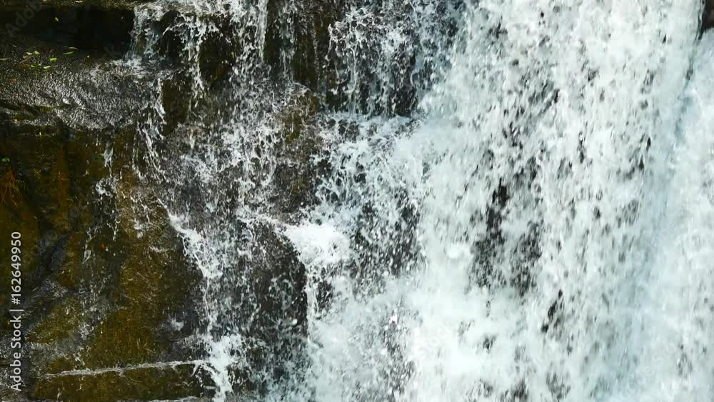 Close up Waterfalls in the rainy season. There is a lot of water flowing into the stones. In the forests of the National Park, include The sound of waterfall. Close up Waterfalls in the rainy season. There is a lot of water flowing into the stones. In the forests of the National Park, include The sound of waterfall.