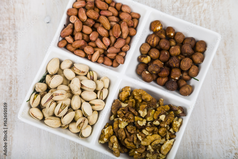 Bowl with nuts on a wooden table Bowl with nuts on a wooden table