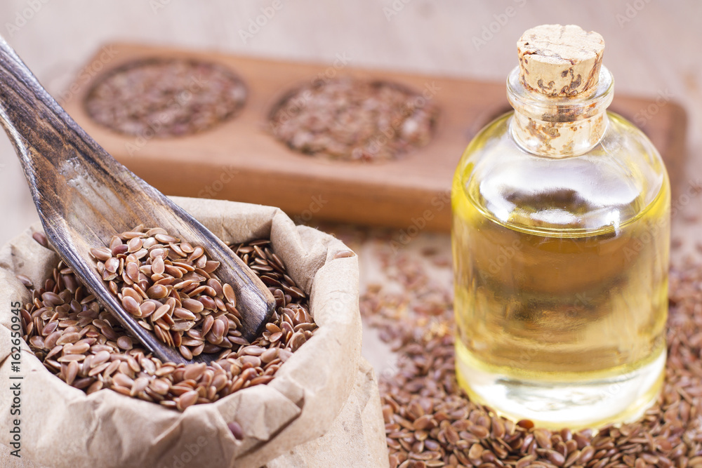 Flax seeds in wooden bowl and spoon Flax seeds in wooden bowl and spoon