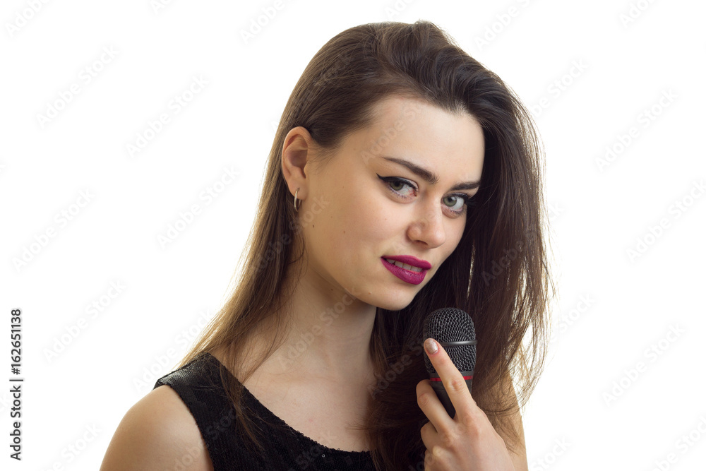 Close up portrait of beautiful young girl with make up and microphone in hands Close up portrait of beautiful young girl with make up and microphone in hands