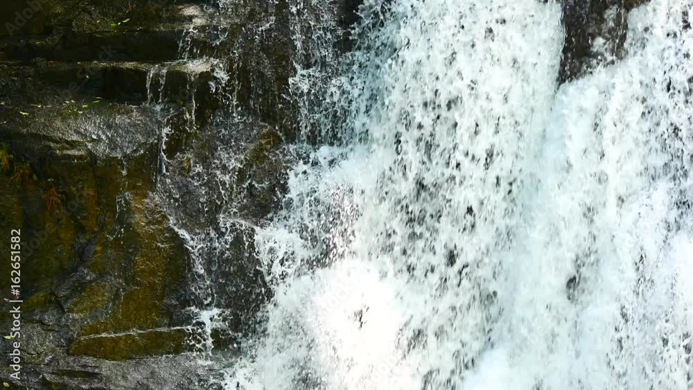 Close up Waterfalls in the rainy season. There is a lot of water flowing into the stones. In the forests of the National Park, include The sound of waterfall. Close up Waterfalls in the rainy season. There is a lot of water flowing into the stones. In the forests of the National Park, include The sound of waterfall.
