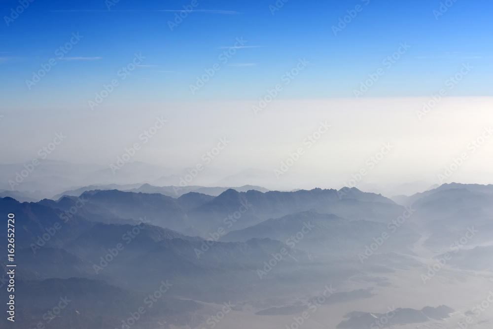 Mountains with blue and white sky above