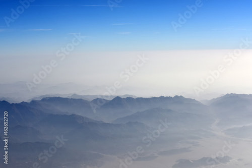 Mountains with blue and white sky above