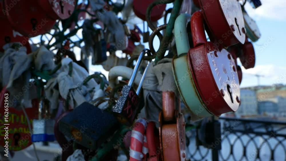 Many padlocks hanging on Lugkov bridge in Moscow, Russia