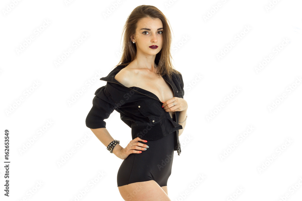Charming young girl take off a jacket without bra under it and looking at  the camera Stock Photo