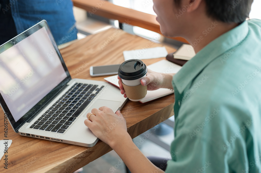 Asian man using laptop in coffee shop Asian man using laptop in coffee shop