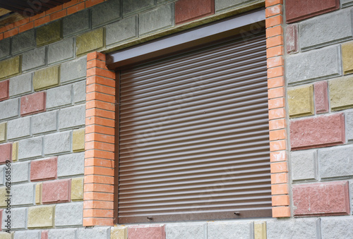 Shutter security barrier. Window with rolling shutter for house protection. Security Shutters Grilles.