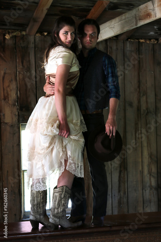 Cowboy holding woman