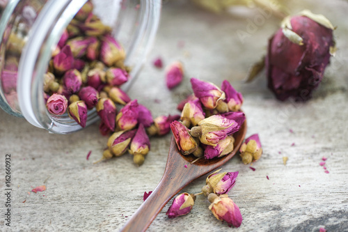 tea made from tea rose petals in a glass bowl on wooden background