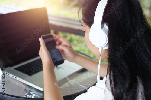young businesswoman listening the music with Earphone, lifestyle concept