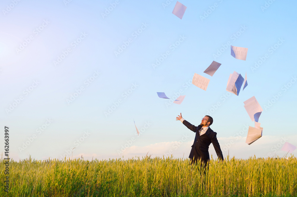 Businessman throws paper in the field, a copy of the free space. Business man in suit, business background. Businessman throws paper in the field, a copy of the free space. Business man in suit, business background.
