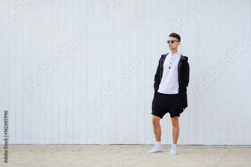 Young fashionable man on a light background © lanarusfoto