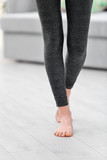 Young girl in grey pants for yoga