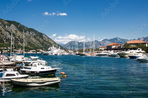 Kotor bay ships and boats in marina with beautiful mountain landscape in background. © Paweł Michałowski