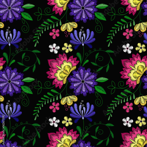 Embroidery seamless pattern with beautiful flowers. Vector floral ornament on black background. Embroidery for fashion textile and fabric. © Alina