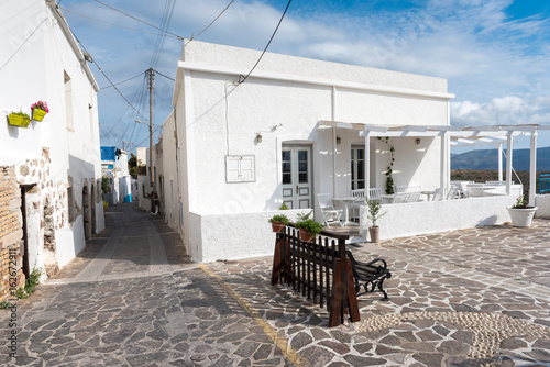 Street with historic white houses and pavement in village of Tripiti on Milos island. Cyclades, Greece.