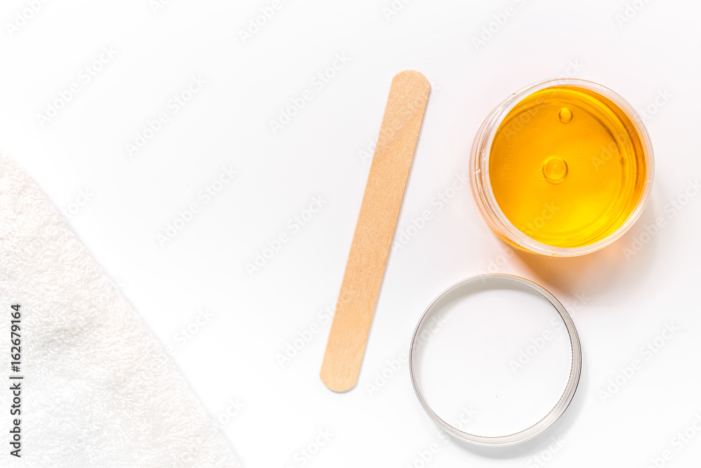 Wax and stick for depilation on white background top view copyspace Wax and stick for depilation on white background top view copyspace
