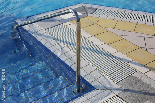 steel handrail to access the pool at a spa