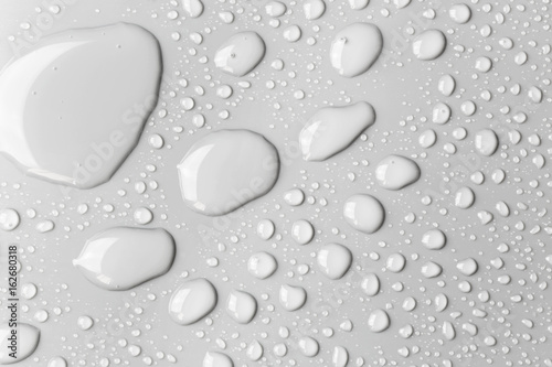 Raindrops on a grey surface  background