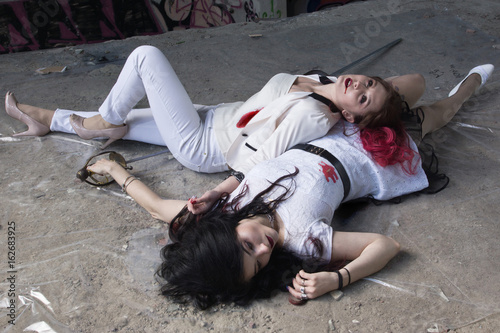 Crime scene with two fashionable women  in a darkplace photo