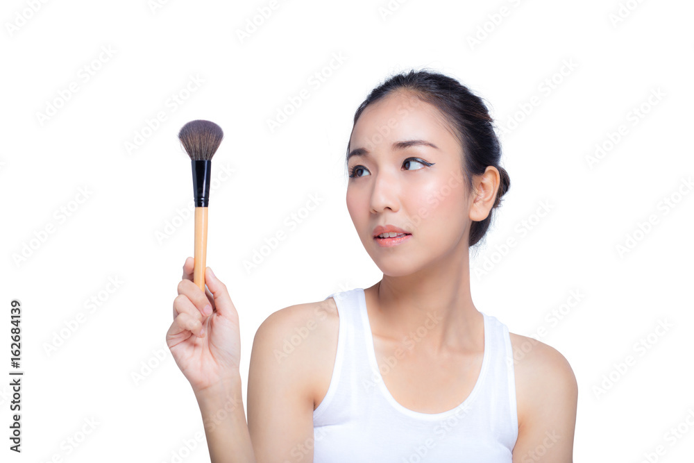 Portrait of the beautiful woman with makeup brushes near face Portrait of the beautiful woman with makeup brushes near face
