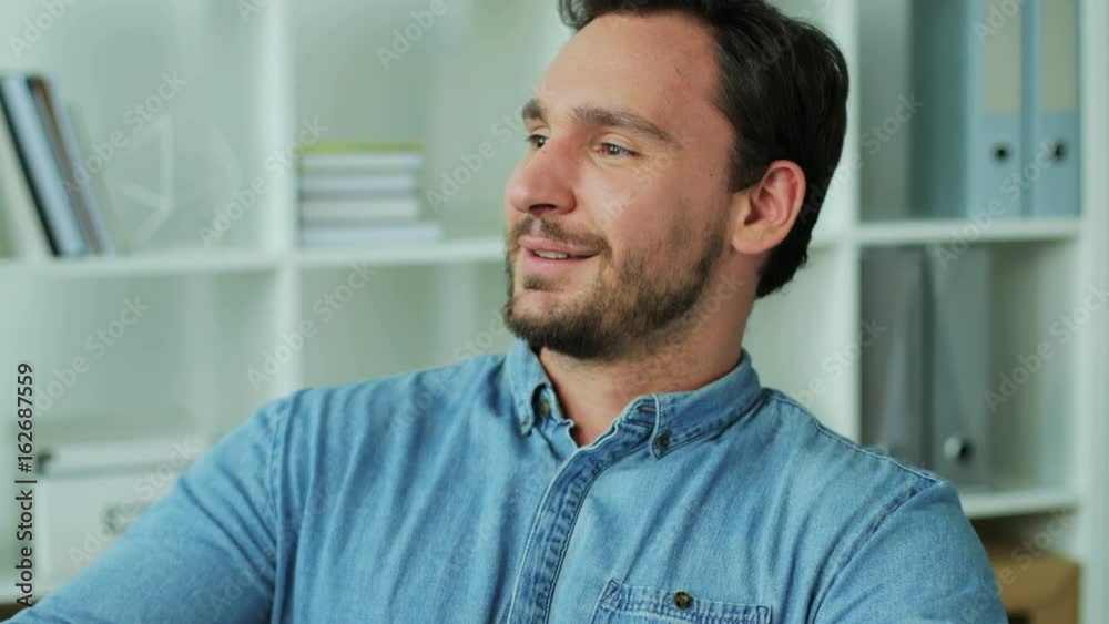 Portrait of attractive business man crossing hands, turning to the camera and smiling. Close up. Portrait of attractive business man crossing hands, turning to the camera and smiling. Close up.