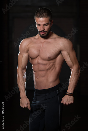 Handsome Model Flexing Muscles © Jale Ibrak