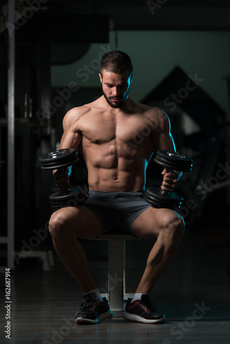 Muscular Model Resting On Bench After Exercise