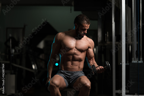 Model With Dumbbells Exercising Biceps