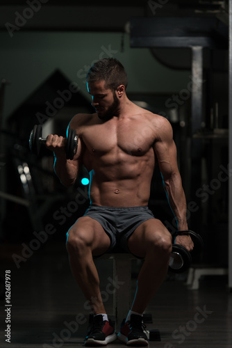 Model With Dumbbells Exercising Biceps
