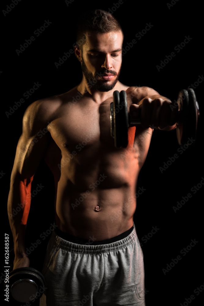 Man Exercise Shoulder With Dumbbells On Black Background