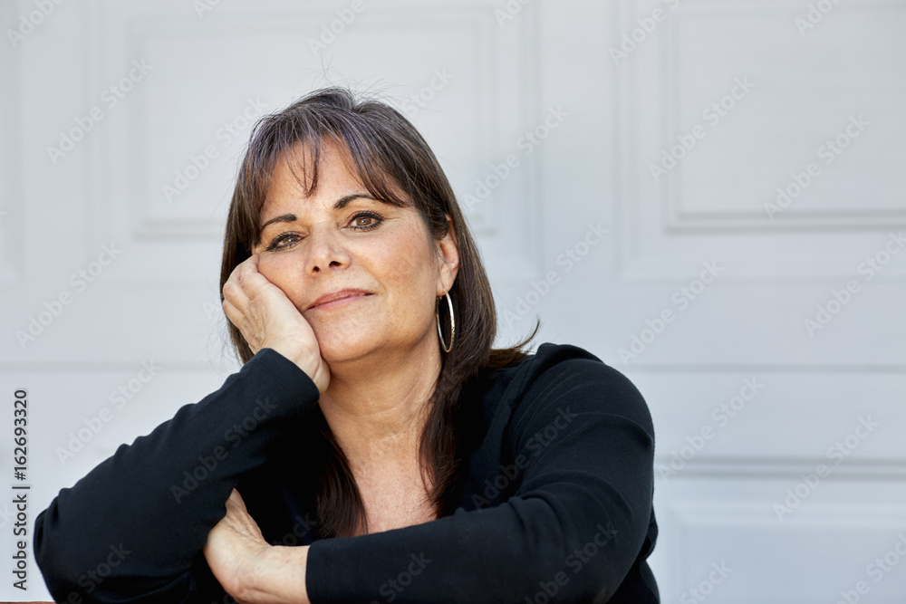 Middle Aged Woman resting face on her hand Middle Aged Woman resting face on her hand