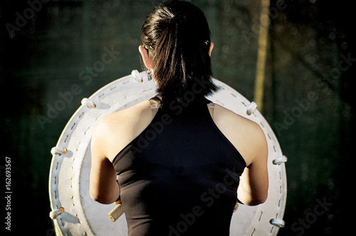 girl from behind playing taiko