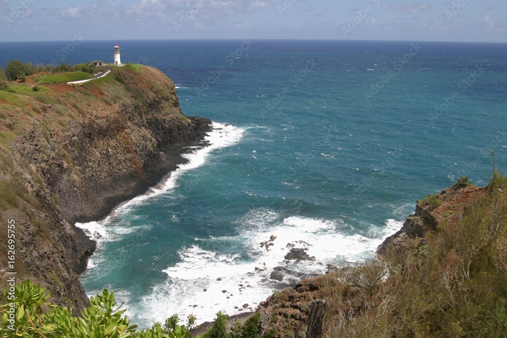 Scenic view of the Kilauea Lighthouse with its breathtaking cove,  a famous landmark and home of Hawai'i's state bird, the nēnē or endangered Hawaiian goose.